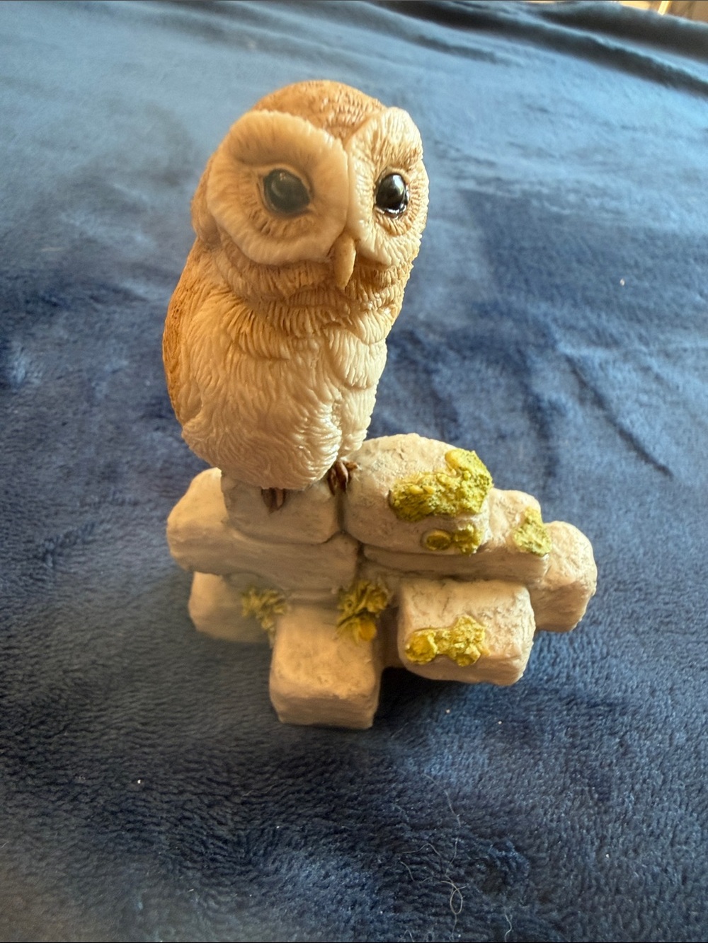 Owl figurine on stone wall